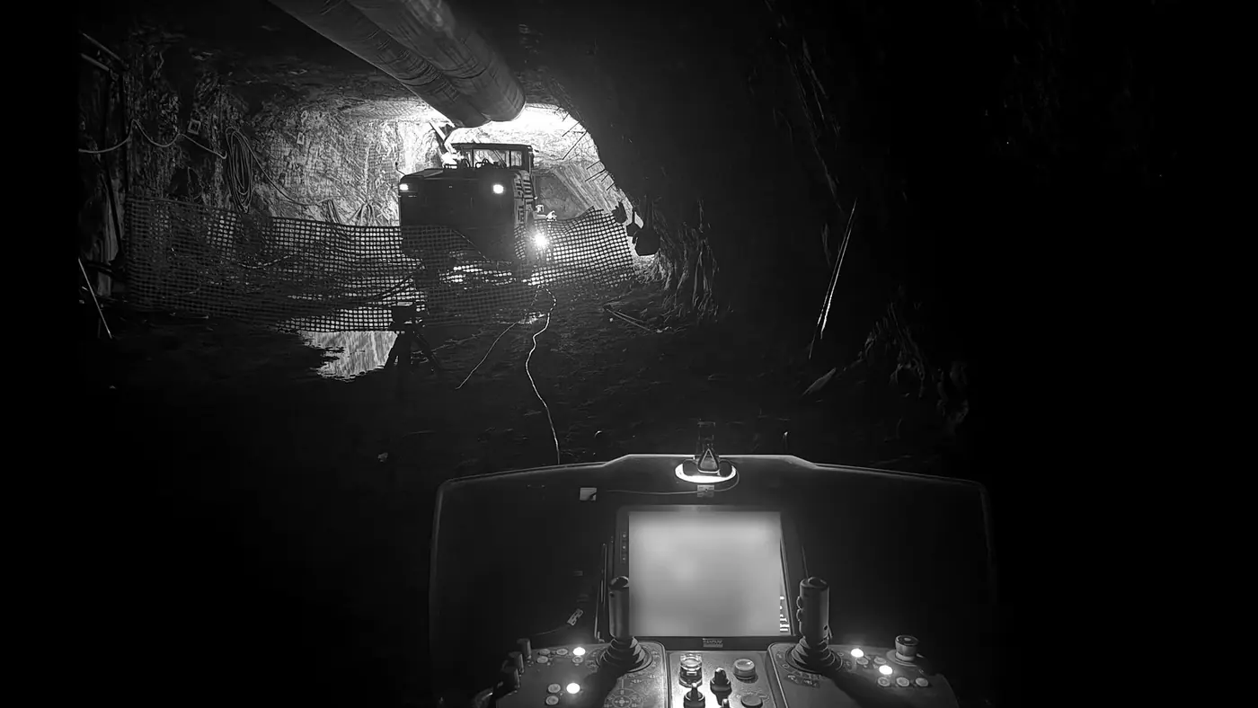 The view from a drill cab toward a lit heading.